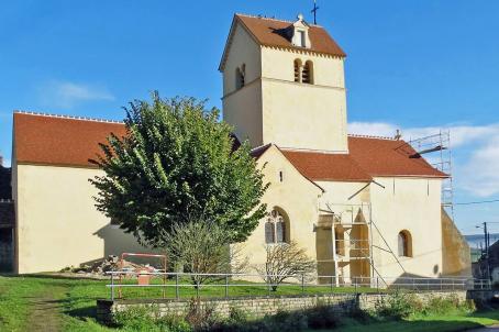 A white church with a tree 