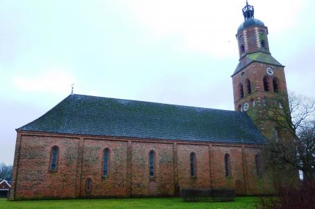 Church built mainly in bricks with a massive bell tower.