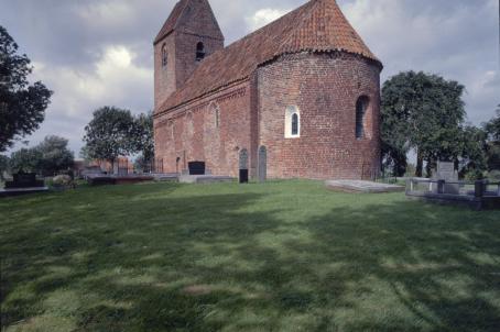 Brick church and graveyard in a field