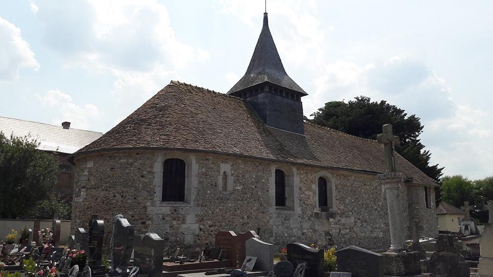 Small church with a pinnacle in a graveyard