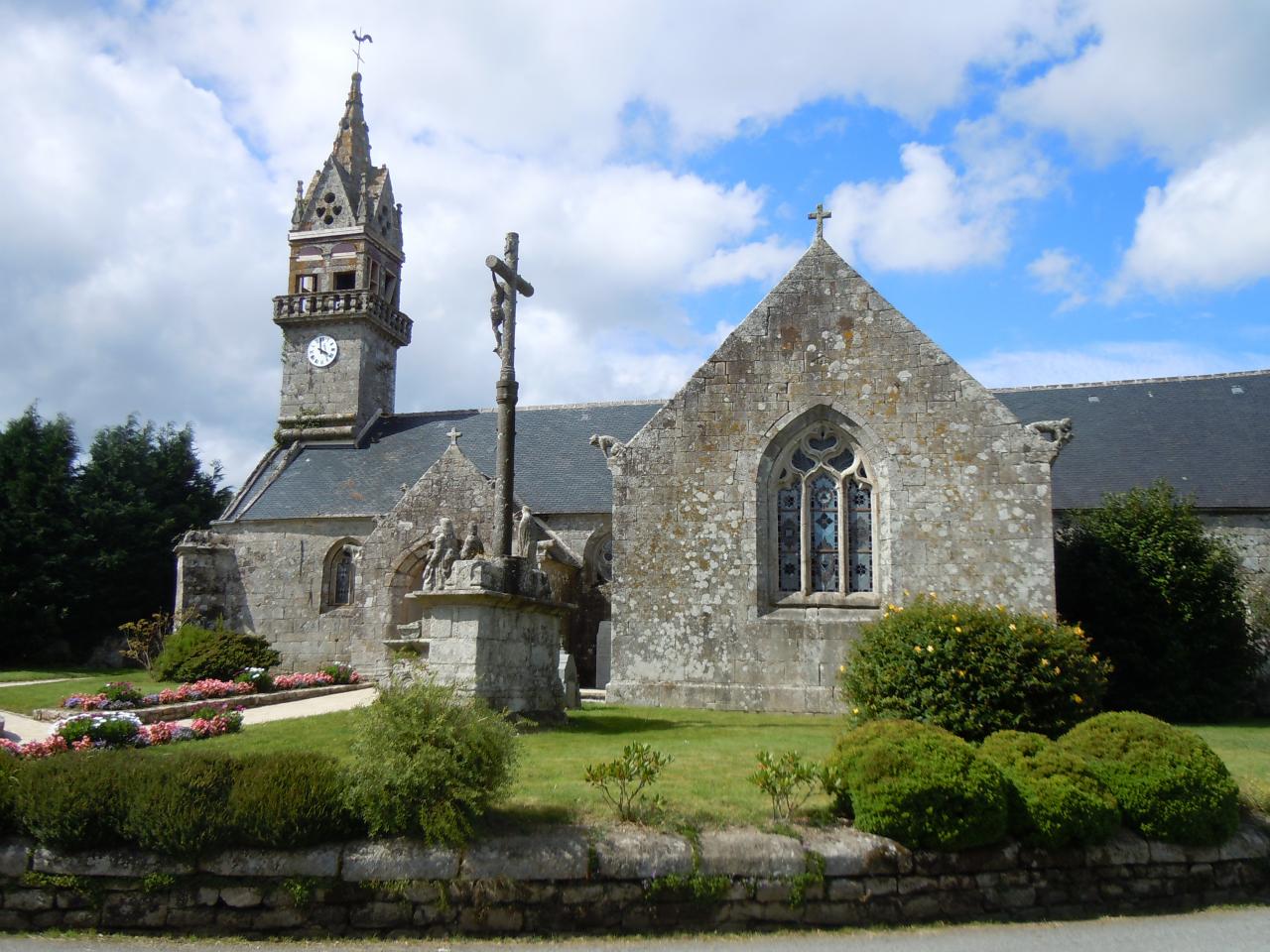 Neo-Gothic church decorated with a turret, spires and a crucifix