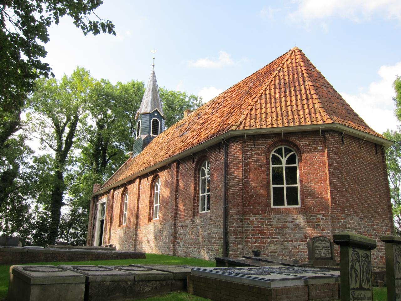 Simple church built mainly in bricks in the countryside.