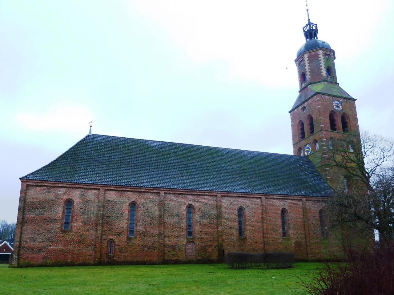 Church built mainly in bricks with a massive bell tower.