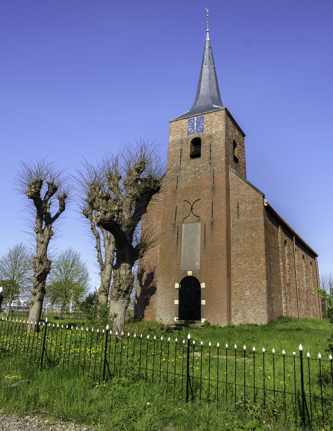 Bell tower of church in a field