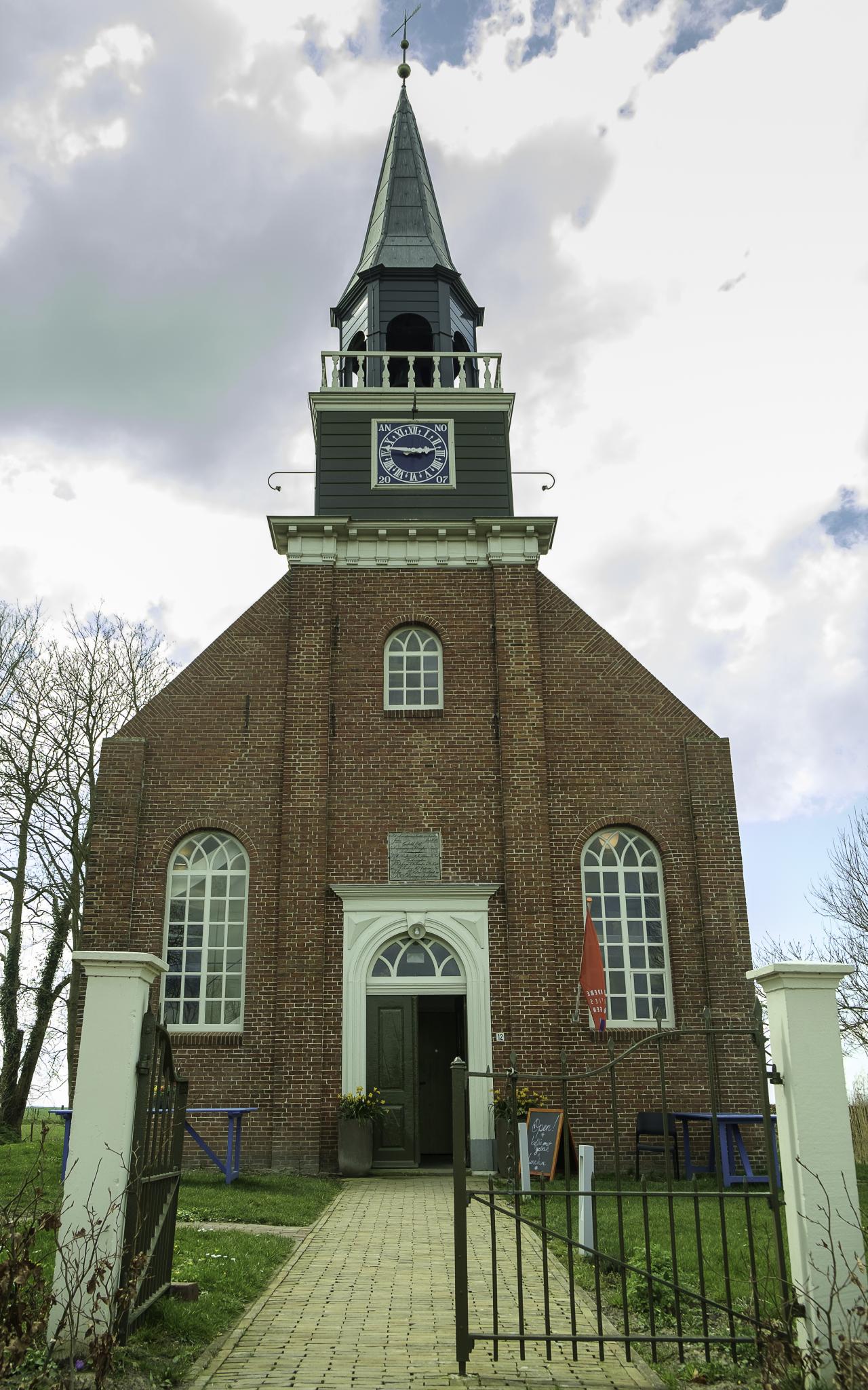 Brick church with pointed roof turret