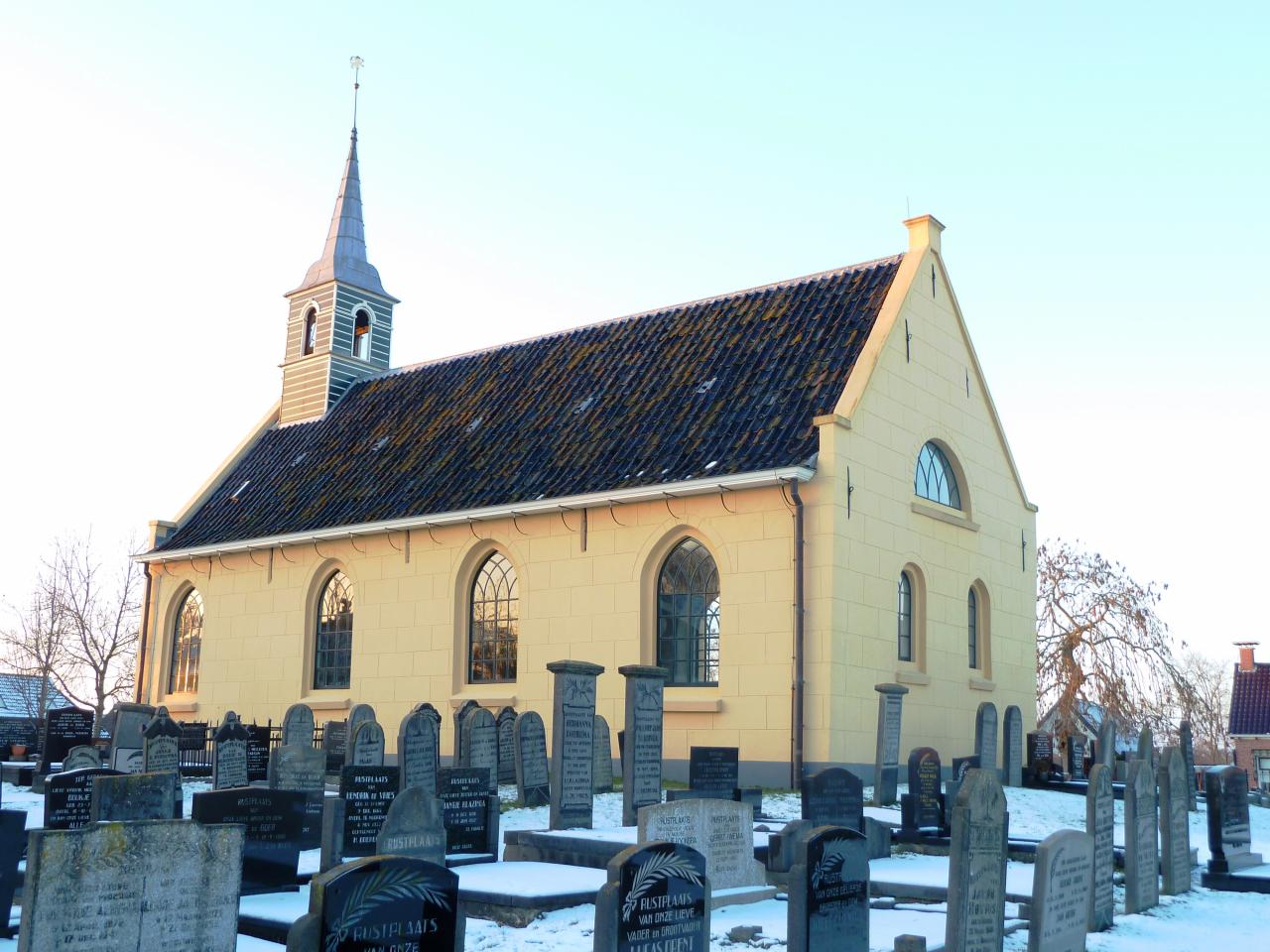 Simple yellow church in a graveyard 