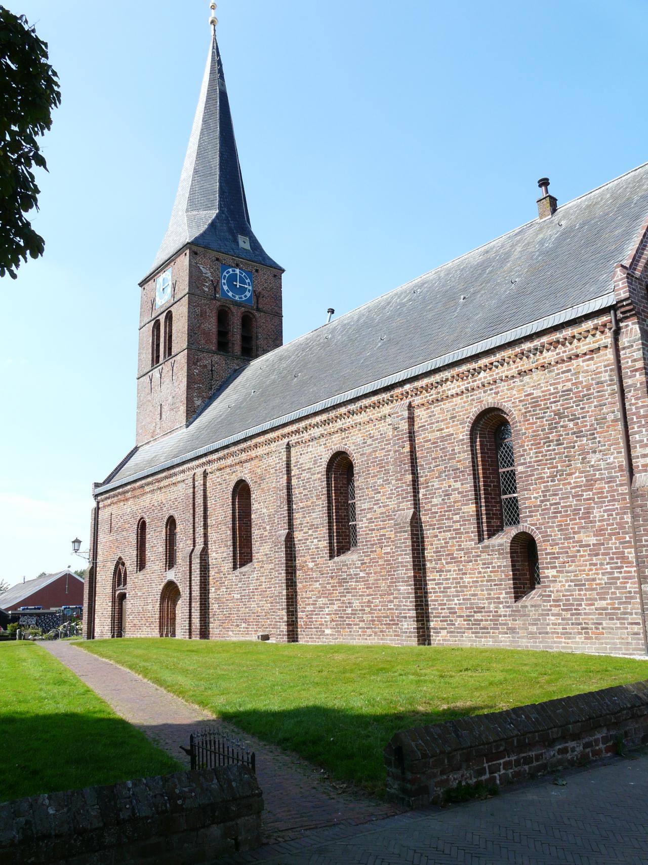 Brick church with a pointed roof bell tower