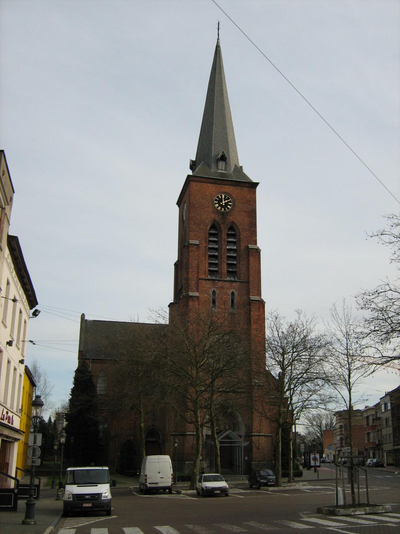 Red church and bell tower with a pointed roof 