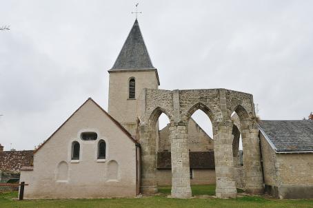 Damaged old church partially enlarged with more recent buildings. The ruins of the old archs are today visible.