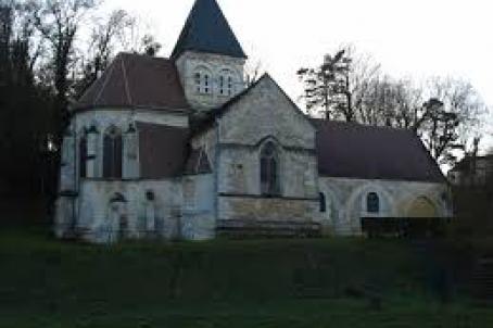 Lateral facade of a 12th century church with a sided view of the choir and the bell tower