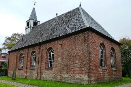 Simple brick chiurch with small turret in a field