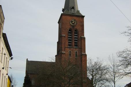 Red church and bell tower with a pointed roof 