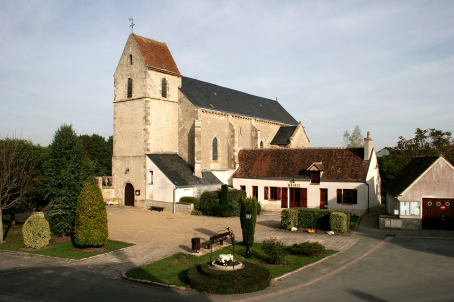 A urban church next to a church, with sandstone walls 