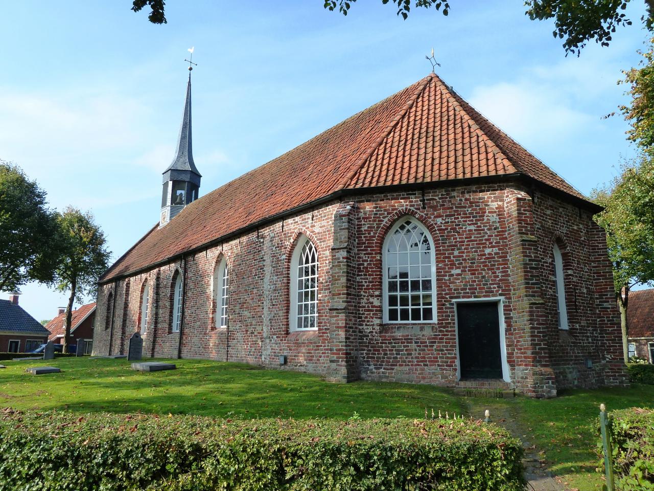 Brick church with a small pointed roof turret 