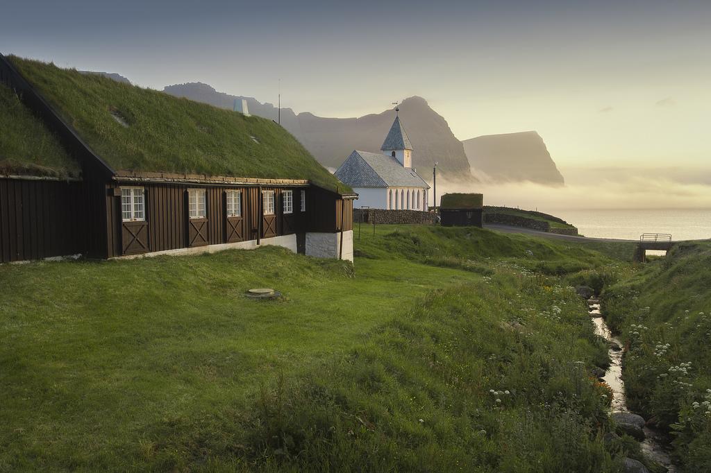 Church in front of a suggestive view of mountains and sea